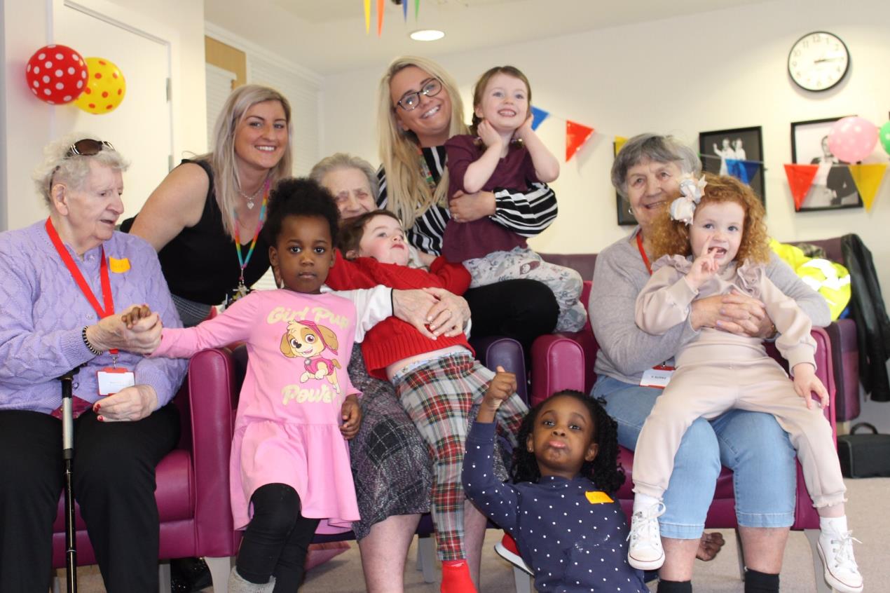 Nursery staff Janine Al Gailani l and Kathryn ONeill with the children and care home residents.