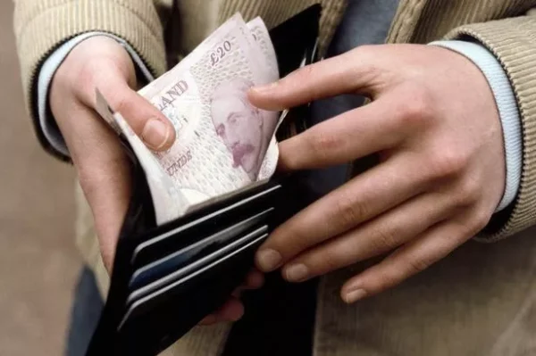 Man with cash in wallet