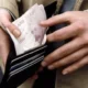 Man with cash in wallet