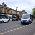 Shops and a bus stop on Drymen Road in Bearsden