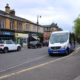 Shops and a bus stop on Drymen Road in Bearsden