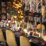 Christmas table set with candles, crystal and gold chairs