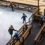 Children skating on a small outdoor ice rink
