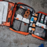 An open red first aid bag full of bandages and dressings