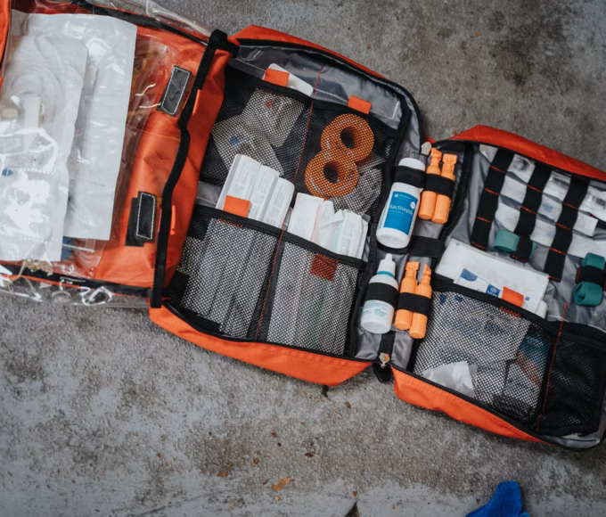 An open red first aid bag full of bandages and dressings
