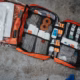 An open red first aid bag full of bandages and dressings